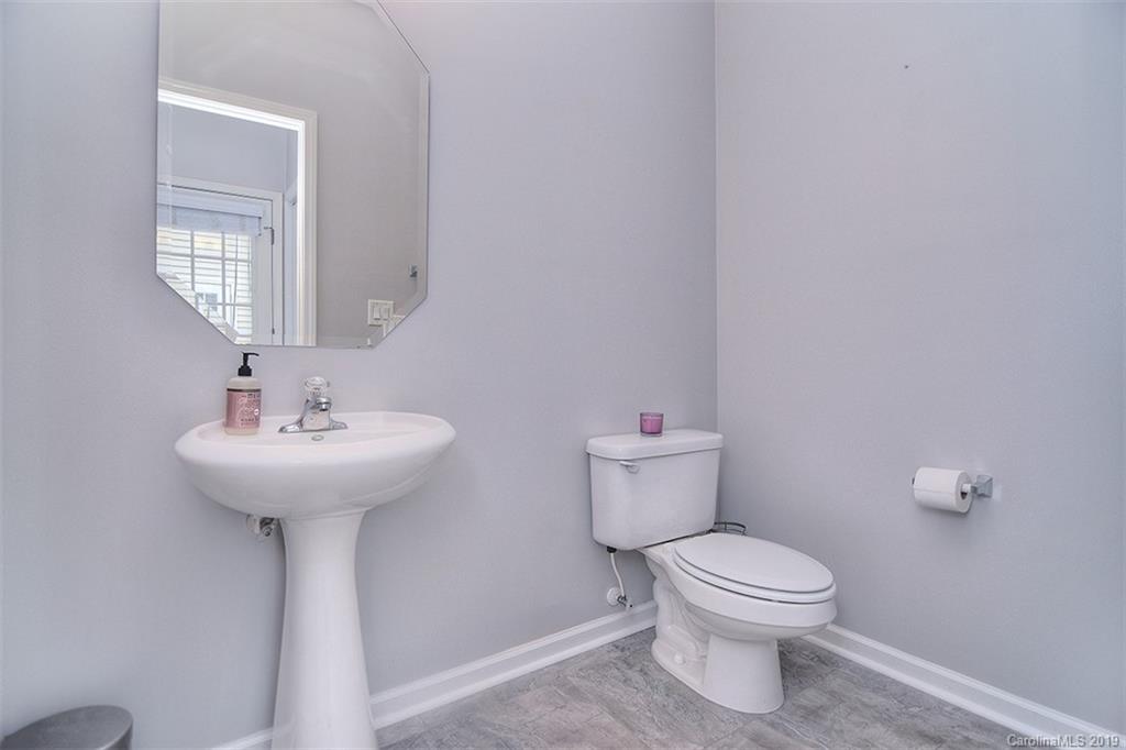 13219 Meadowmere Road Huntersville, NC 28078 - Photo 8 of 28 a white toilet sitting next to a bathroom sink