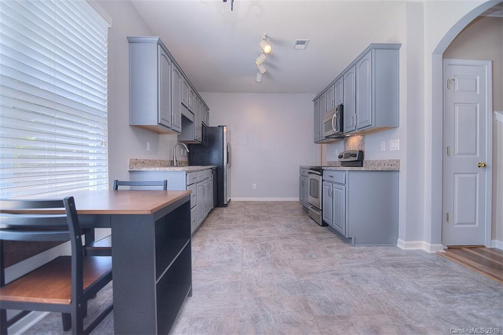 13219 Meadowmere Road Huntersville, NC 28078 - Photo 10 of 28 a kitchen with stainless steel appliances a sink stove and cabinets