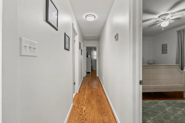 a bathroom with a toilet sink vanity and mirror