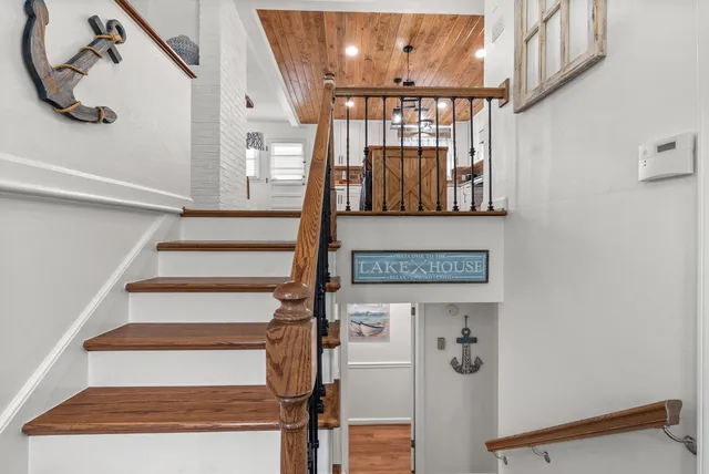 a house view with swimming pool in front of the house