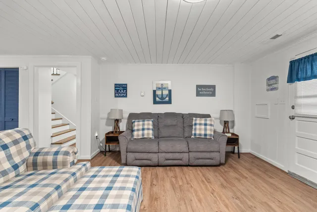 an aerial view of a house with a yard and lake view