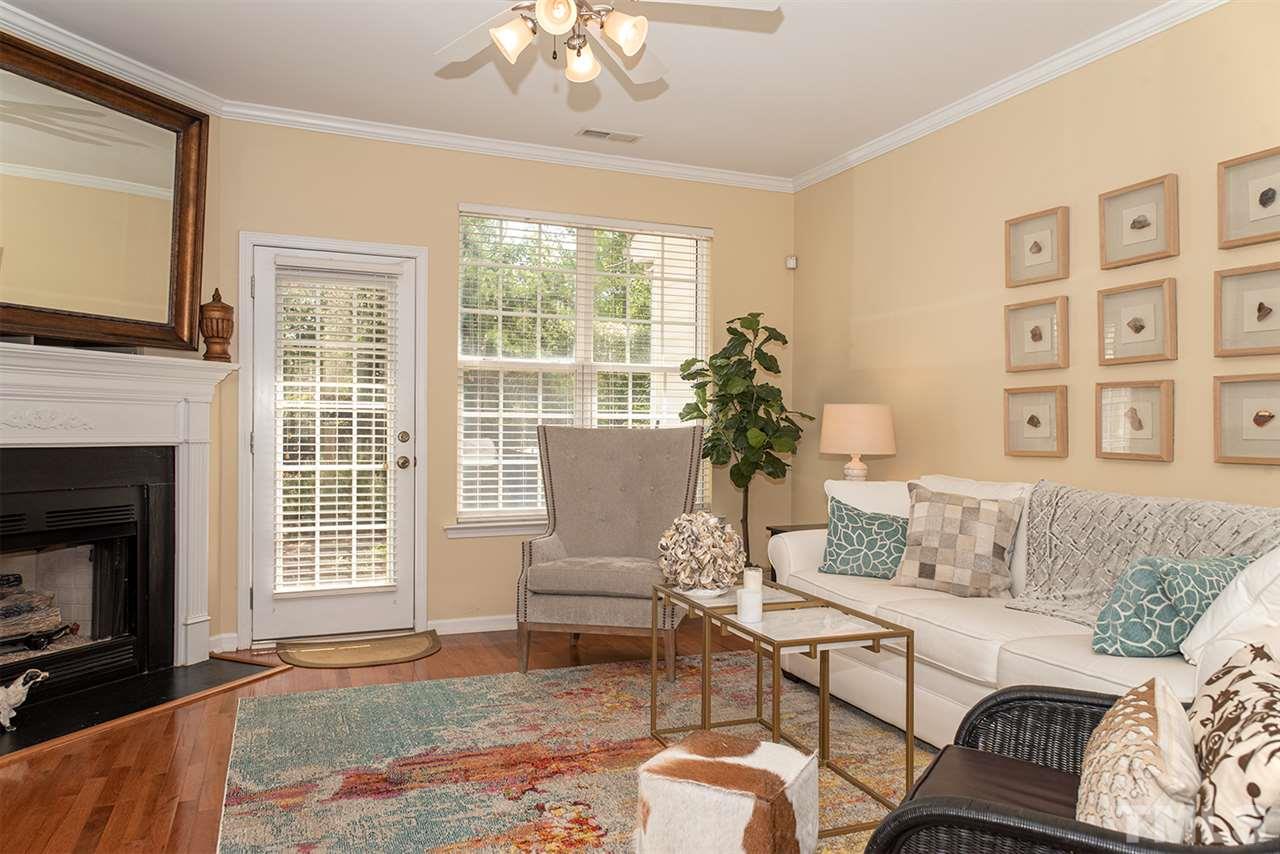 8272 City Loft Court Raleigh, NC 27613 - Photo 13 of 26 a living room with furniture and a fireplace