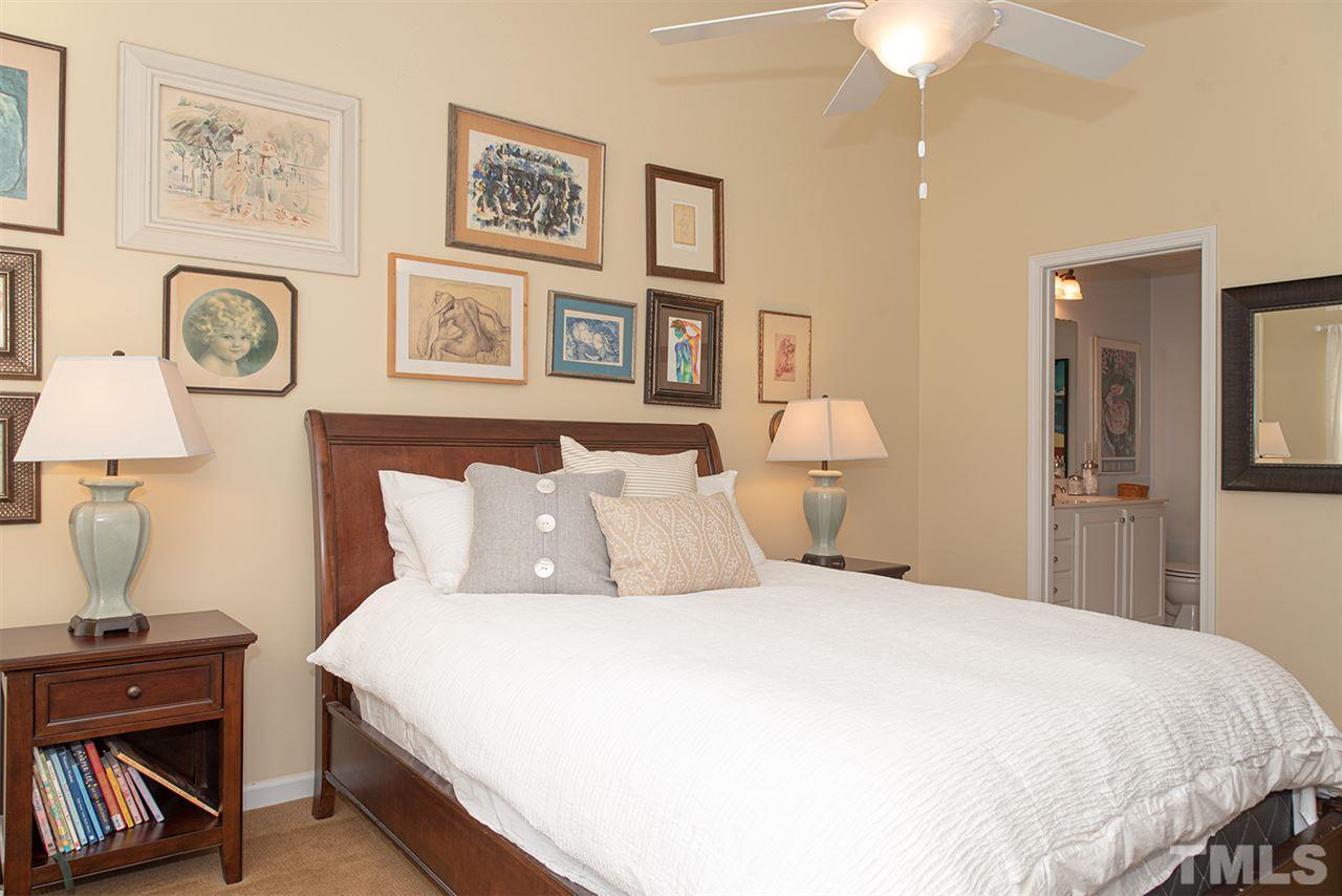 8272 City Loft Court Raleigh, NC 27613 - Photo 16 of 26 a bedroom with a bed and a lamp on dresser