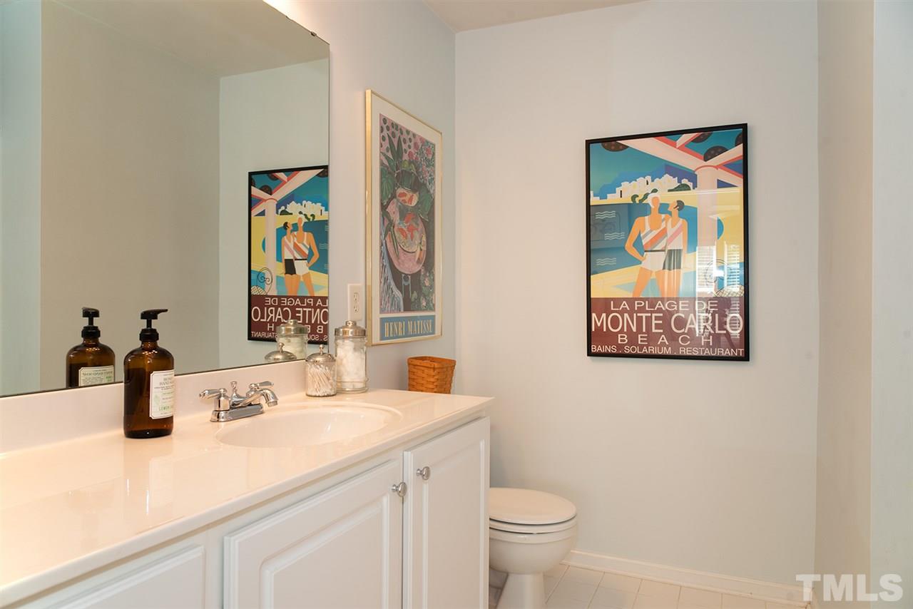 8272 City Loft Court Raleigh, NC 27613 - Photo 18 of 26 a bathroom with a sink mirror and toilet