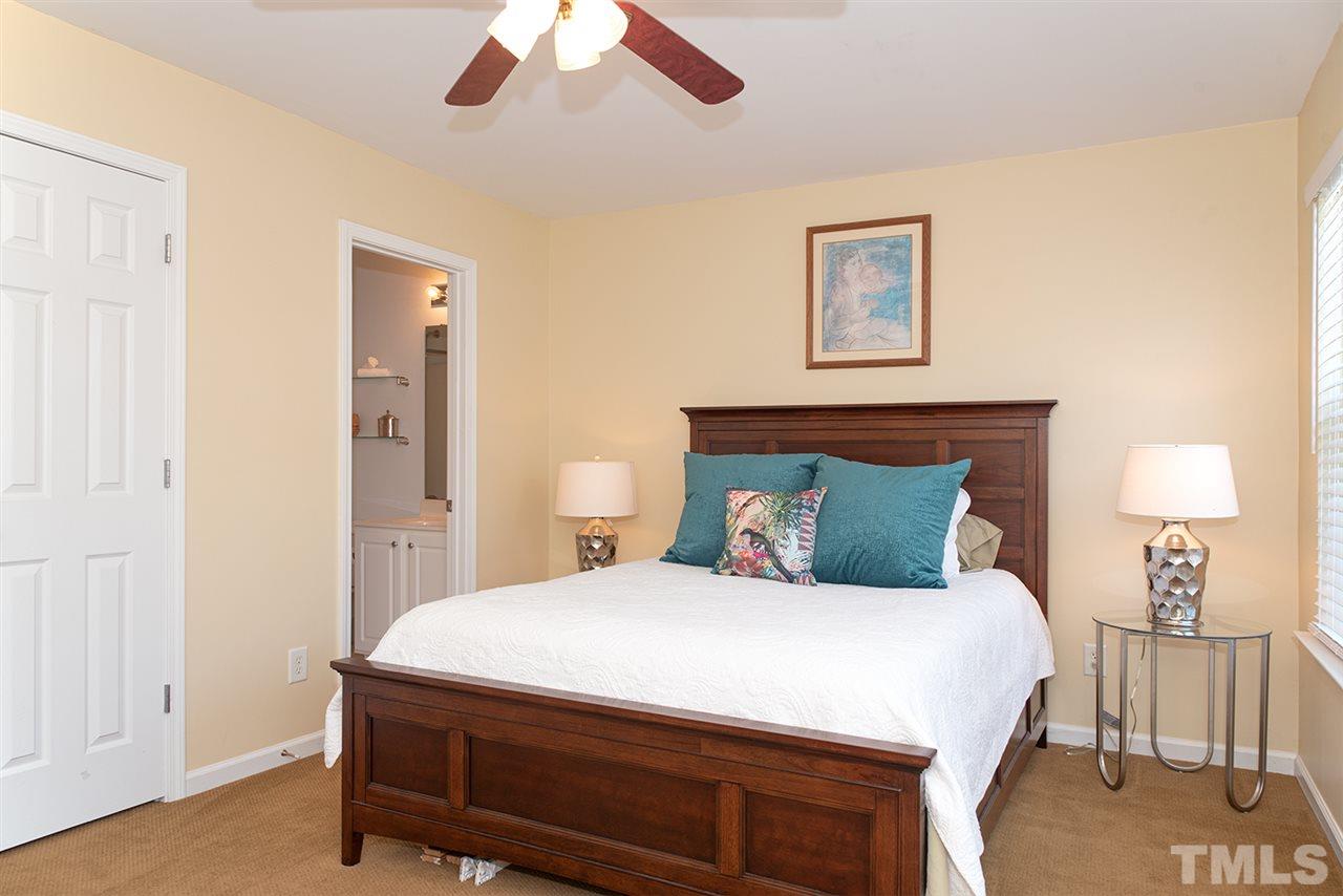 8272 City Loft Court Raleigh, NC 27613 - Photo 21 of 26 a bedroom with a bed and a lamp
