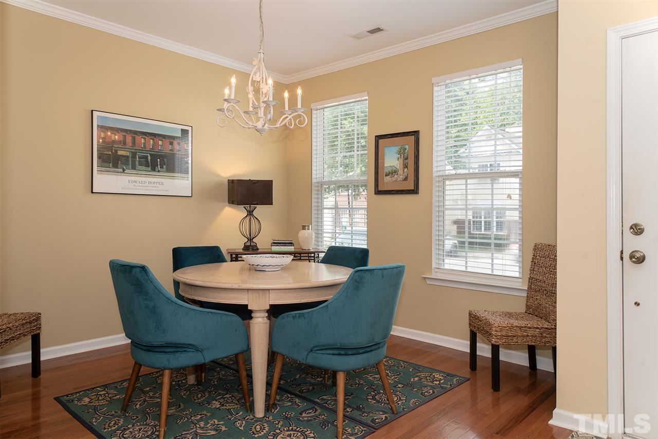 8272 City Loft Court Raleigh, NC 27613 - Photo 4 of 26 a view of a dining room with furniture window and wooden floor