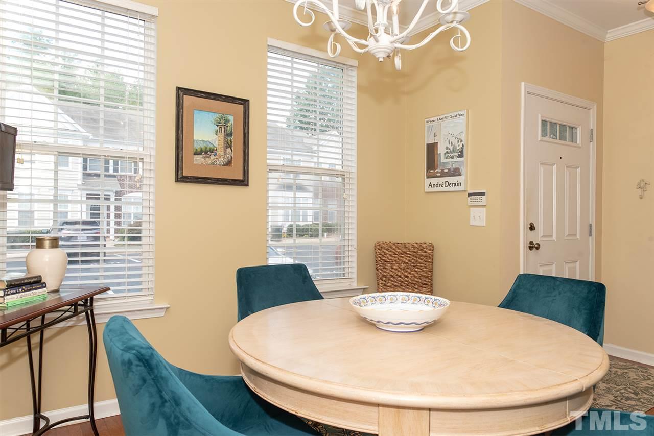 8272 City Loft Court Raleigh, NC 27613 - Photo 5 of 26 a dining room with table chairs and wooden floor