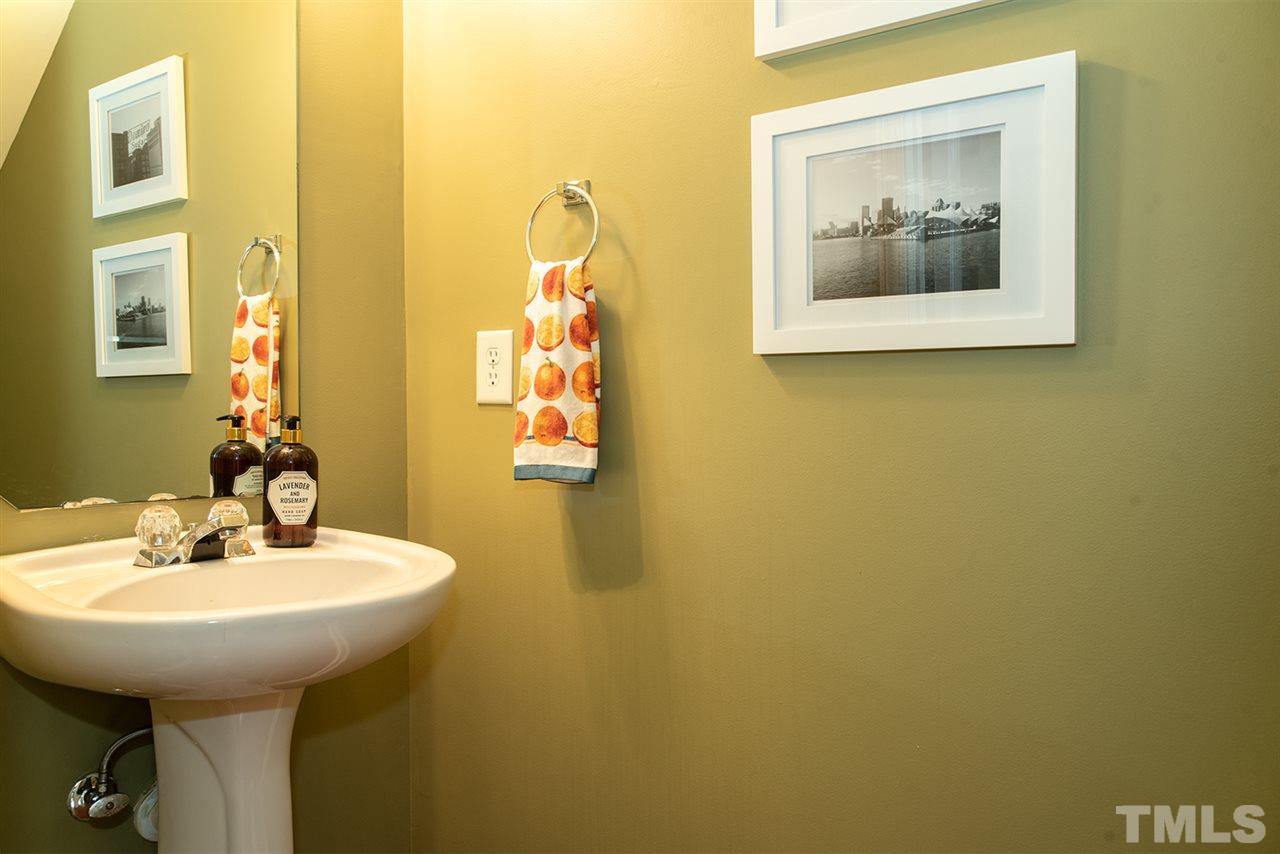 8272 City Loft Court Raleigh, NC 27613 - Photo 6 of 26 a bathroom with a sink and a mirror