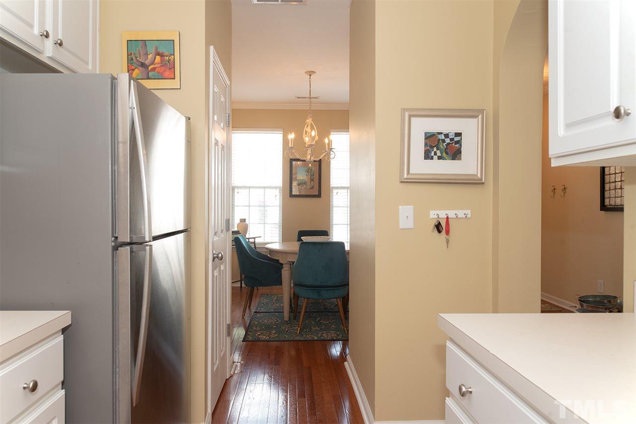 8272 City Loft Court Raleigh, NC 27613 - Photo 8 of 26 a kitchen with a refrigerator and a stove