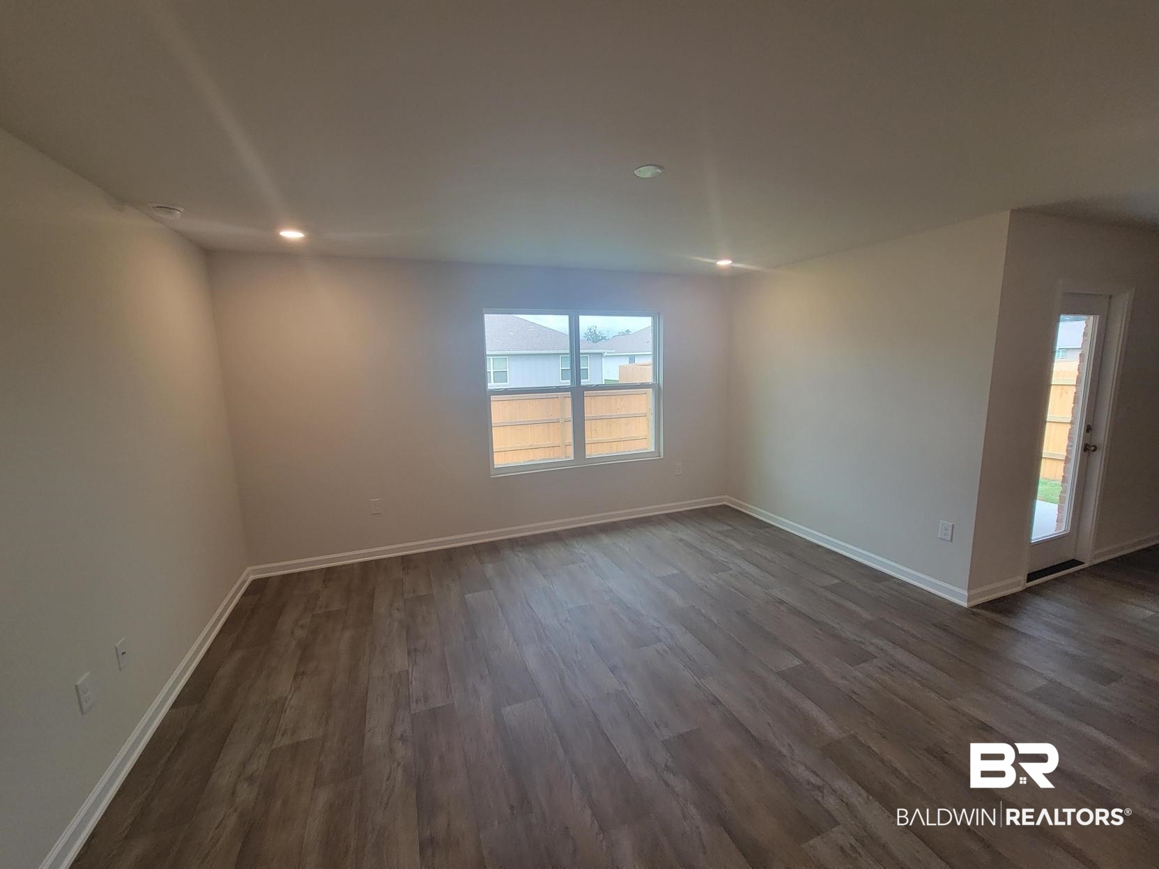 24625 Ponder Loop Loxley, AL 36551 - Photo 2 of 30 Spare room with dark hardwood / wood-style flooring