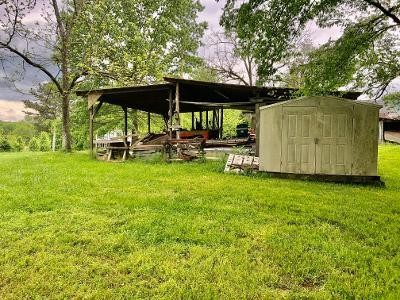 143 Reagan Road Southeast Cleveland, TN 37323 - Photo 7 of 8 a view of backyard with table and chairs under an umbrella