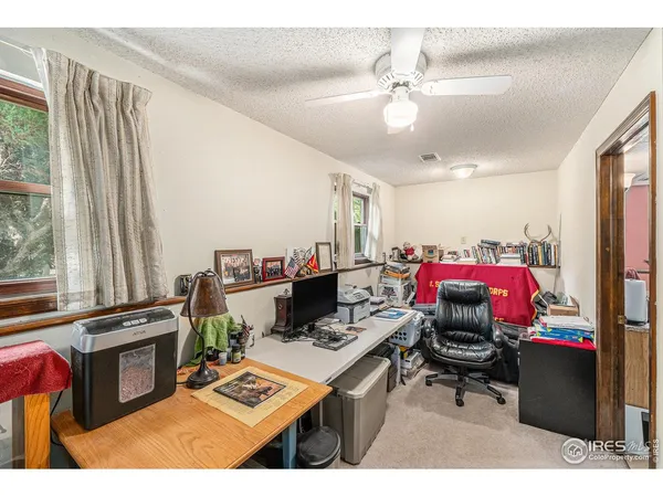 a living room with furniture a flat screen tv and a window