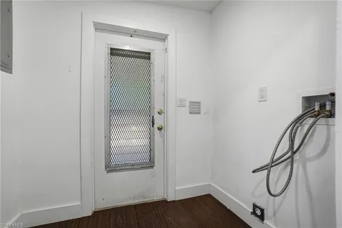 a view of a hallway with wooden floor and closet