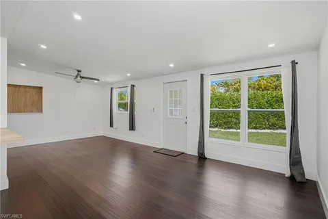 a view of an empty room and kitchen appliances