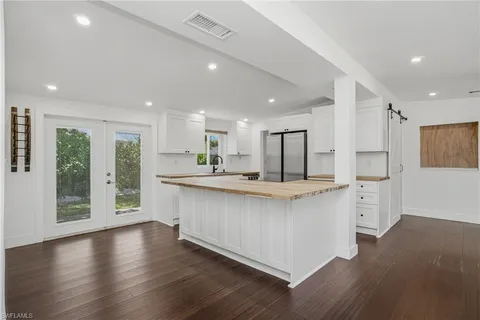 a kitchen with sink stove and refrigerator