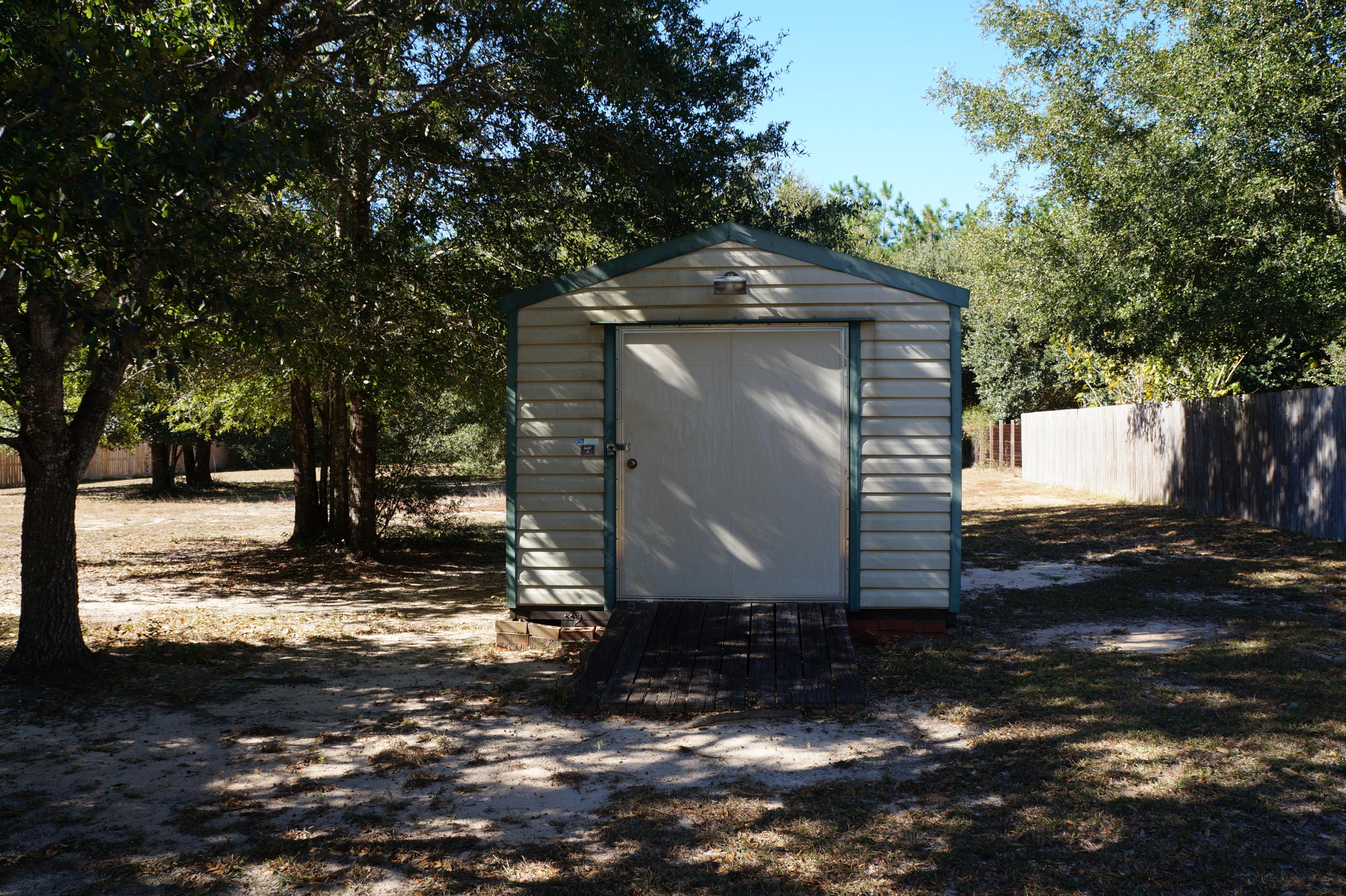 5534 Mulat Road Milton, FL 32583 - Photo 13 of 67 a view of a barn in the middle of a yard