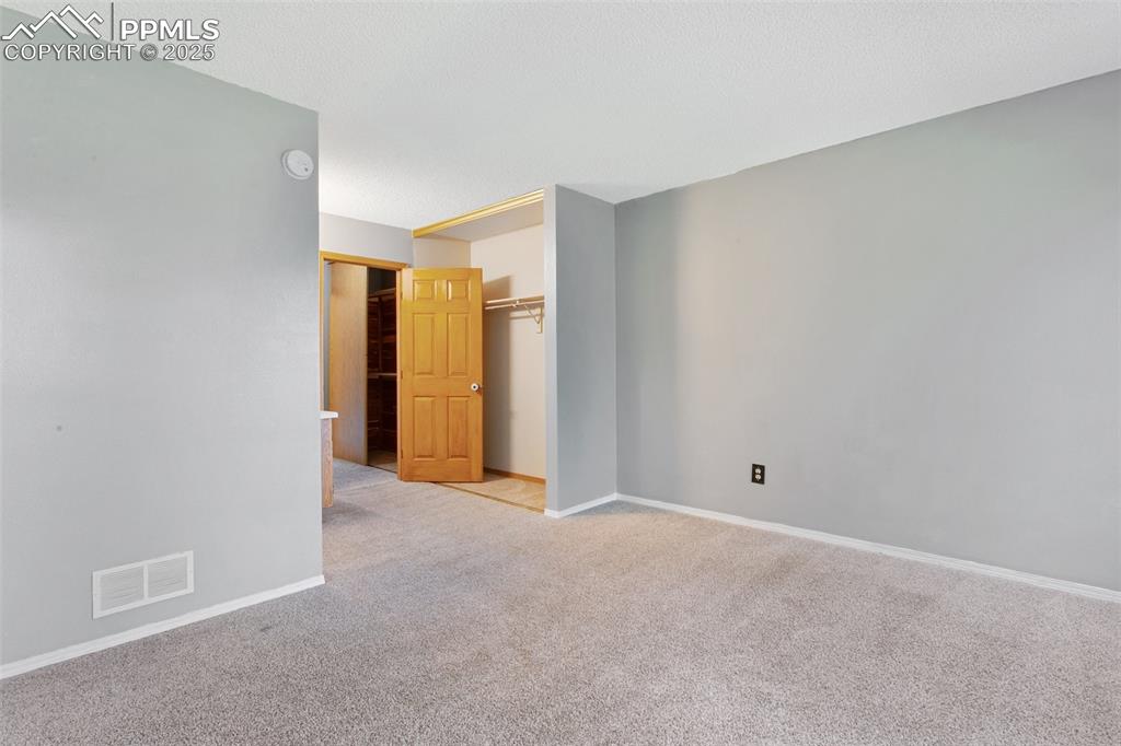 3457 Queen Anne Way Colorado Springs, CO 80917 - Photo 13 of 25 Carpeted empty room featuring baseboards and a smoke detector