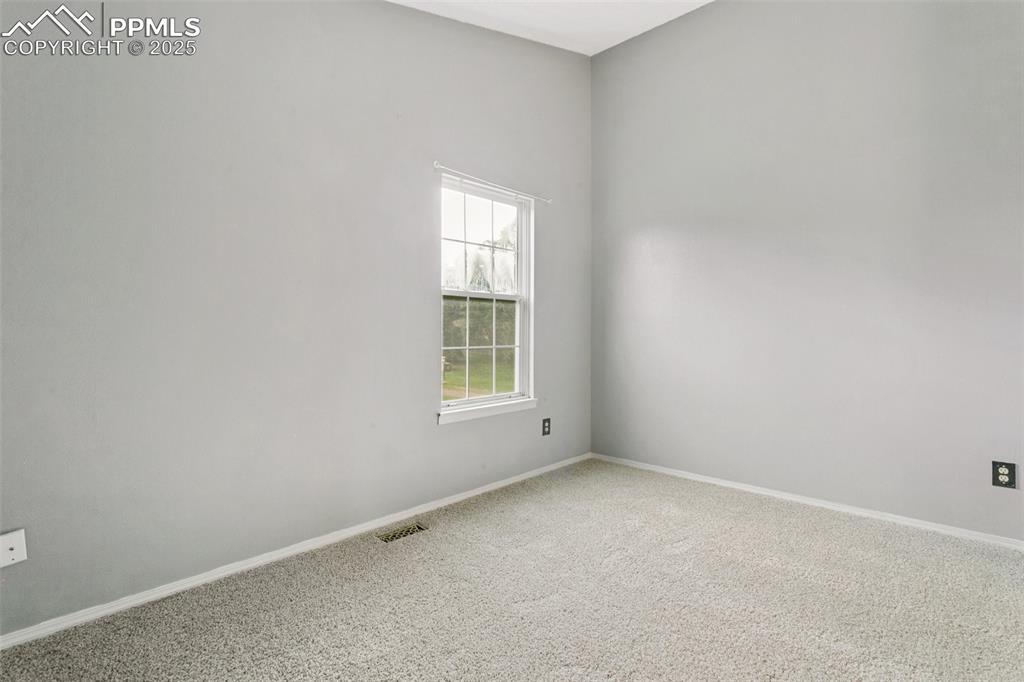 3457 Queen Anne Way Colorado Springs, CO 80917 - Photo 15 of 25 Unfurnished room with carpet flooring and baseboards