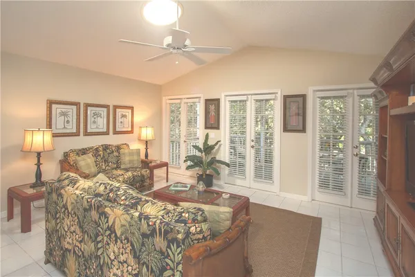 a spacious bedroom with a bed and glass walk in closet