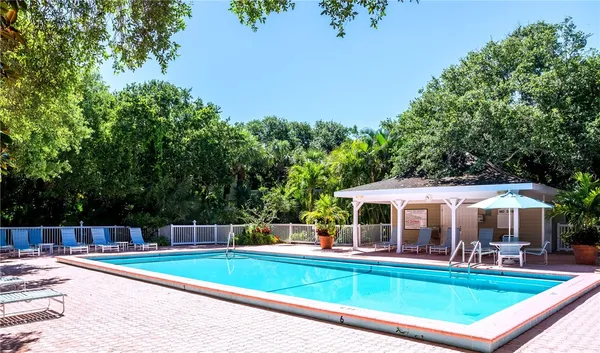 a view of a house with swimming pool and sitting area