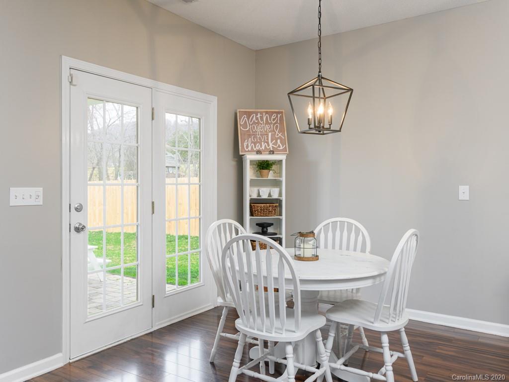 180 Wildbriar Road, Unit 12 Fletcher, NC 28732 - Photo 11 of 33 a view of a dining room with furniture a chandelier and wooden floor