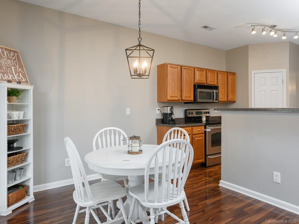180 Wildbriar Road, Unit 12 Fletcher, NC 28732 - Photo 13 of 33 a view of a dining room with furniture a kitchen and wooden floor