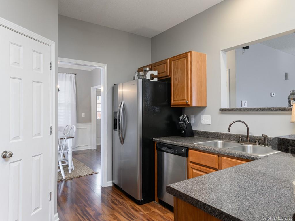 180 Wildbriar Road, Unit 12 Fletcher, NC 28732 - Photo 15 of 33 a kitchen with stainless steel appliances granite countertop a sink and a refrigerator