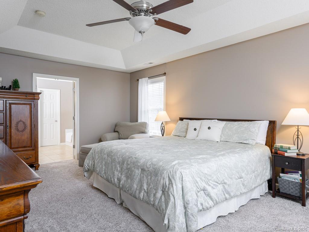 180 Wildbriar Road, Unit 12 Fletcher, NC 28732 - Photo 17 of 33 a bedroom with a bed and ceiling fan