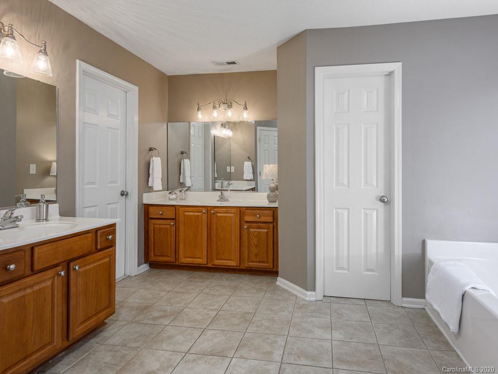 180 Wildbriar Road, Unit 12 Fletcher, NC 28732 - Photo 18 of 33 a large bathroom with a double vanity sink a mirror and a shower