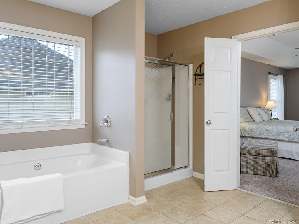 180 Wildbriar Road, Unit 12 Fletcher, NC 28732 - Photo 19 of 33 a bathroom with a bathtub and a shower