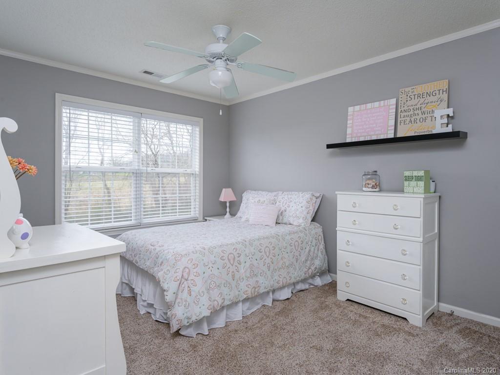 180 Wildbriar Road, Unit 12 Fletcher, NC 28732 - Photo 21 of 33 a bedroom with a bed and a window