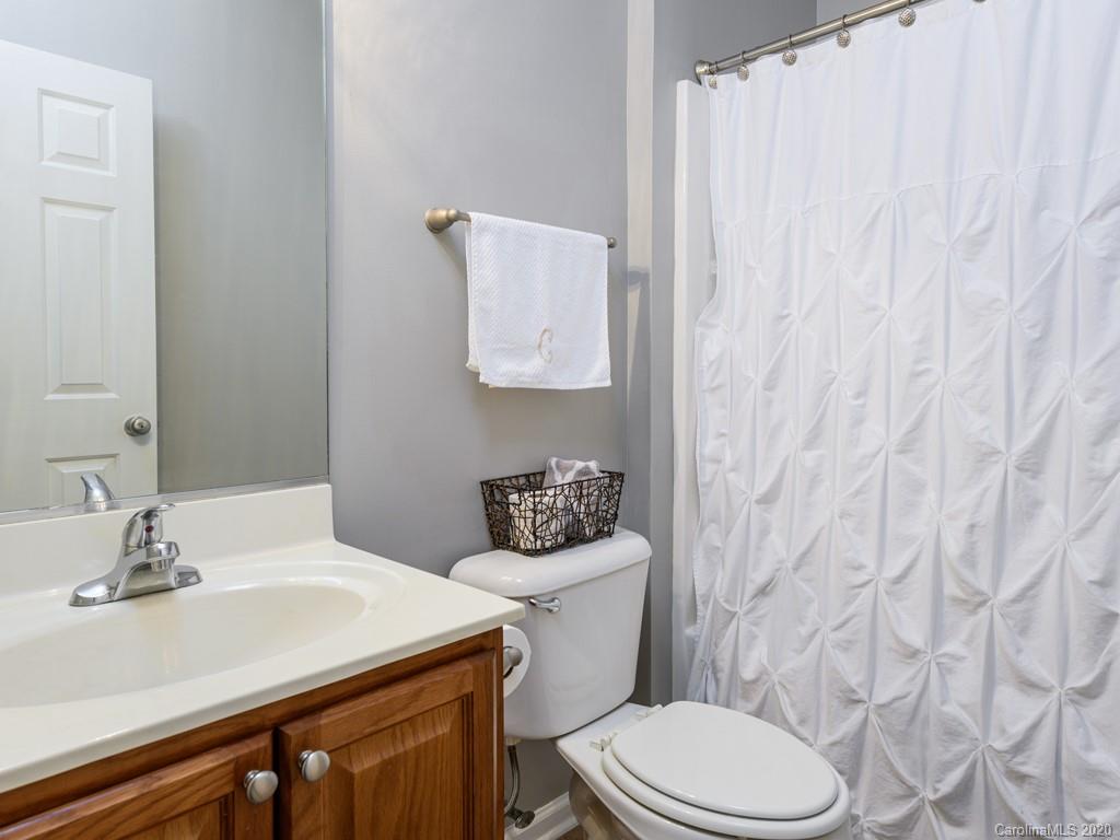 180 Wildbriar Road, Unit 12 Fletcher, NC 28732 - Photo 22 of 33 a bathroom with a granite countertop sink and a toilet