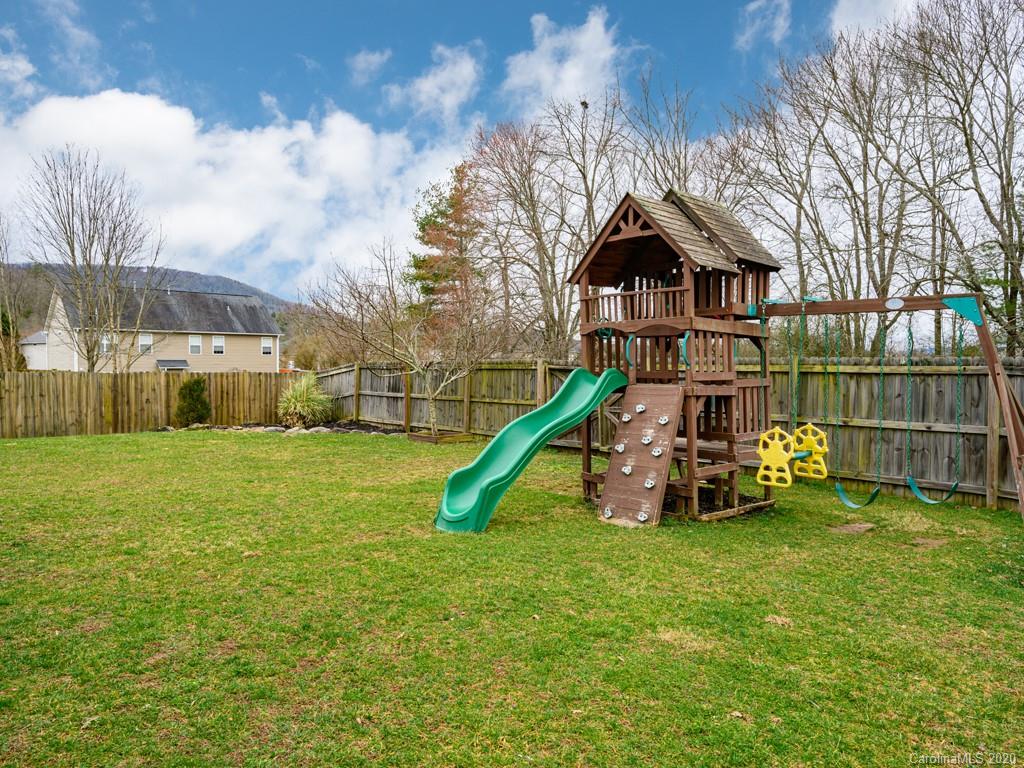 180 Wildbriar Road, Unit 12 Fletcher, NC 28732 - Photo 30 of 33 a view of a house with backyard and a slide