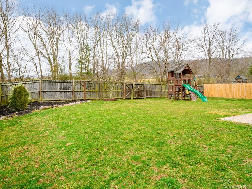 180 Wildbriar Road, Unit 12 Fletcher, NC 28732 - Photo 31 of 33 a view of yard with swimming pool and trees in the background