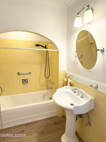 a bathroom with a sink a mirror and a bathtub