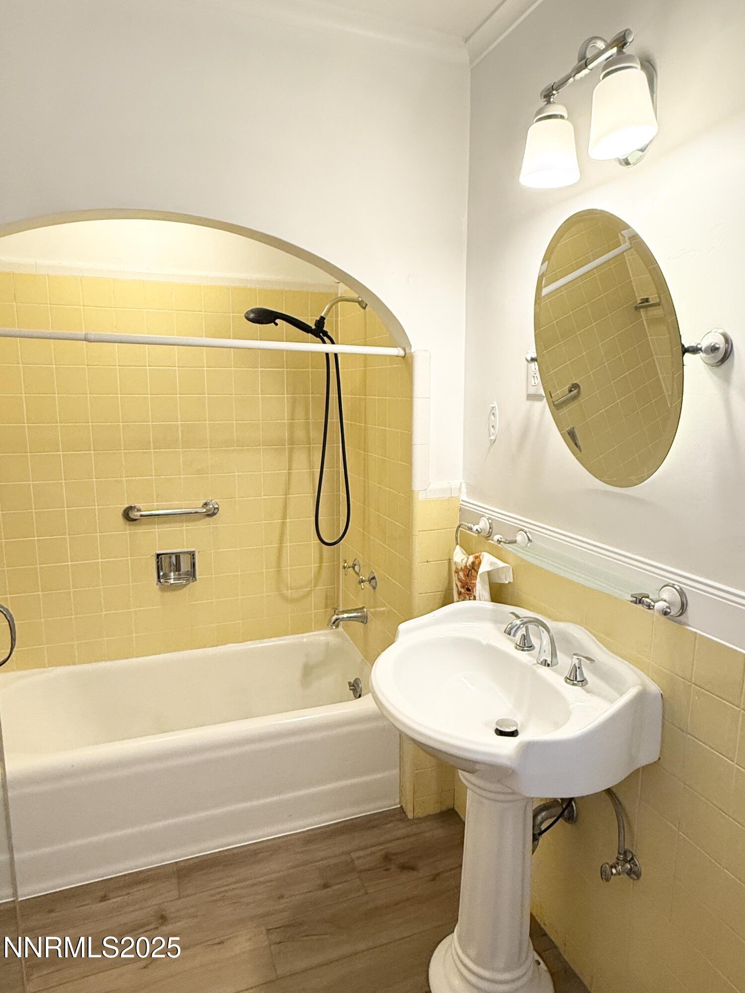 531 East Taylor Street Reno, NV 89502 - Photo 11 of 15 a bathroom with a sink a mirror and a bathtub