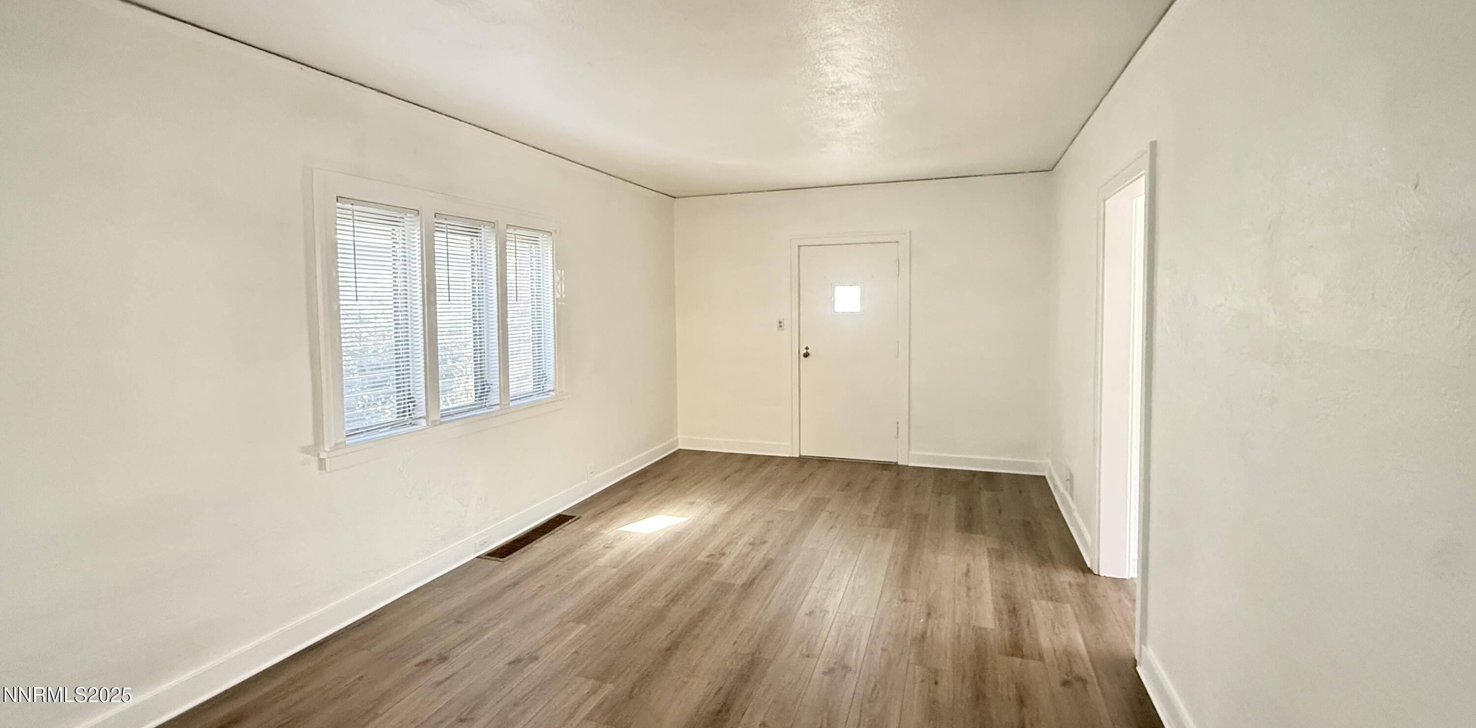 531 East Taylor Street Reno, NV 89502 - Photo 7 of 15 an empty room with wooden floor and windows