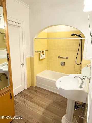 a bathroom with a tub and shower