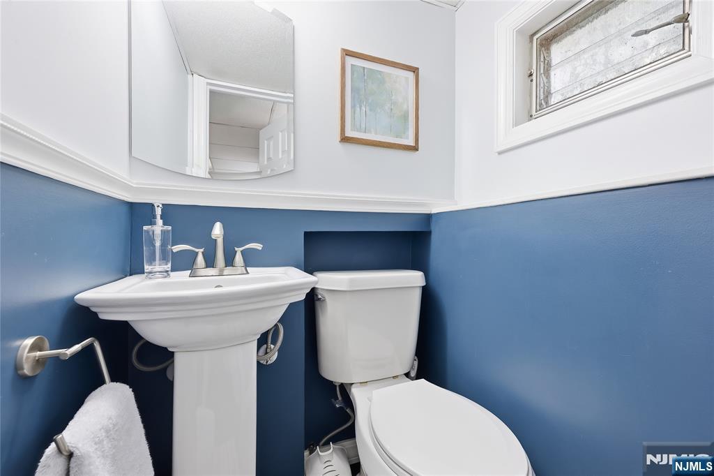 77 White Pond Road Waldwick, NJ 07463 - Photo 28 of 33 a bathroom with a toilet sink and mirror