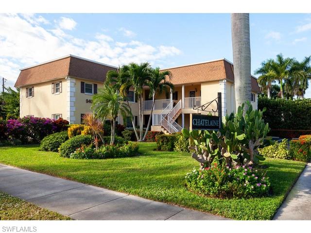 940 3rd Street South, Unit 104 Naples, FL 34102 - Photo 2 of 8 a front view of a house with a yard