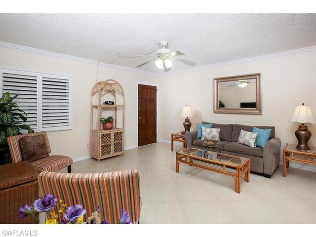 940 3rd Street South, Unit 104 Naples, FL 34102 - Photo 4 of 8 a bedroom with furniture and a window