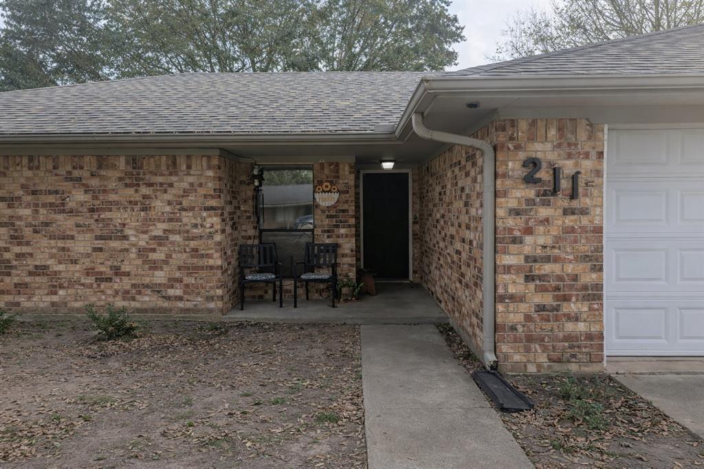 211 McAfee Street Mabank, TX 75147 - Photo 2 of 20 a view of a patio with table and chairs with wooden floor and plants