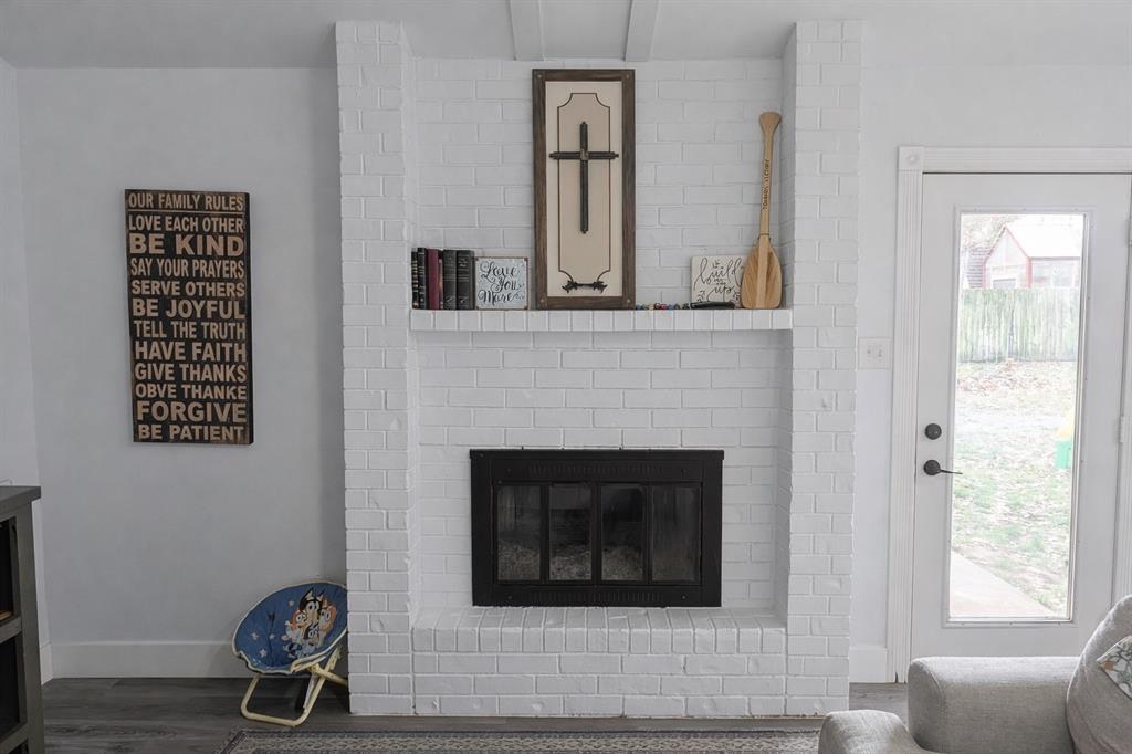 211 McAfee Street Mabank, TX 75147 - Photo 5 of 20 a living room with furniture and a fireplace