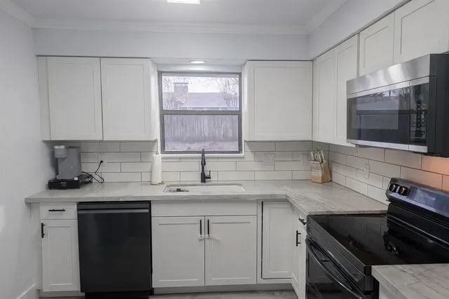 a kitchen with a sink stove and microwave