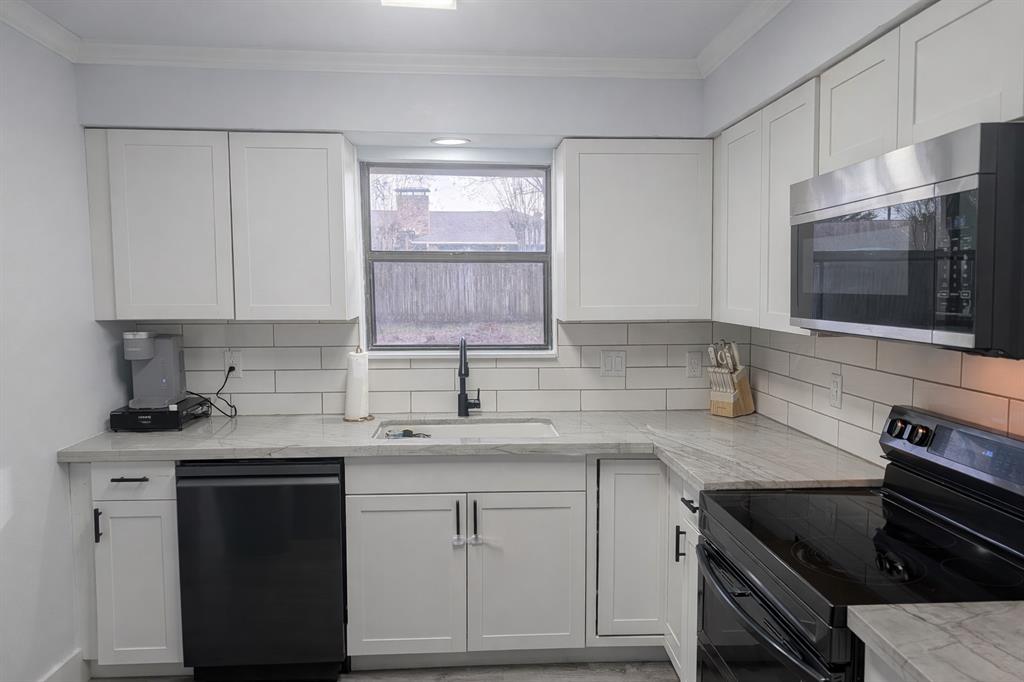 211 McAfee Street Mabank, TX 75147 - Photo 7 of 20 a kitchen with a sink stove and microwave