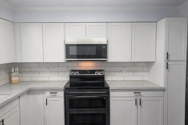 a kitchen with a stove and a microwave