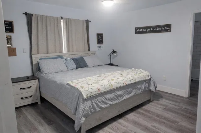 a bedroom with a bed and a window