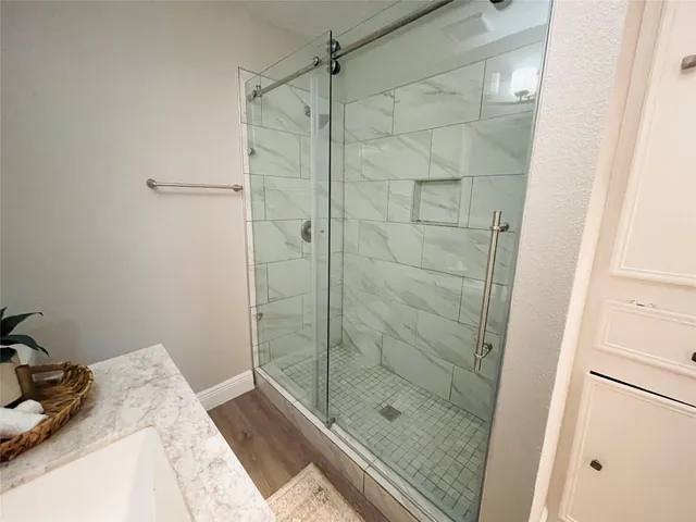 a bathroom with a shower and a sink