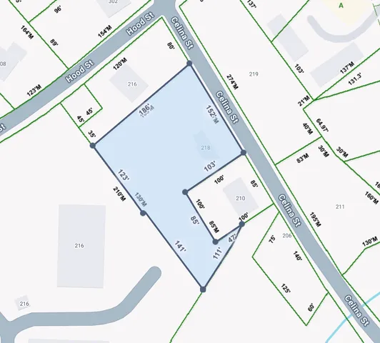 a view of a living room with wooden floor and white walls