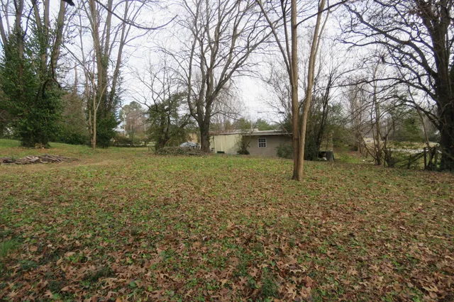 a backyard of a house with large trees